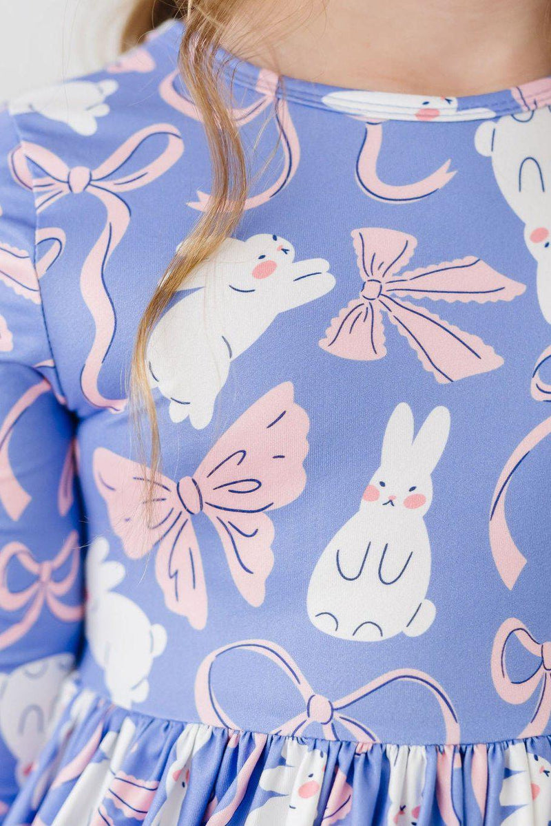 Close-up of the Hop, Skip & Twirl 3/4 Sleeve Pocket Twirl Dress highlighting its colorful bunny and bow design, perfect for little ones.