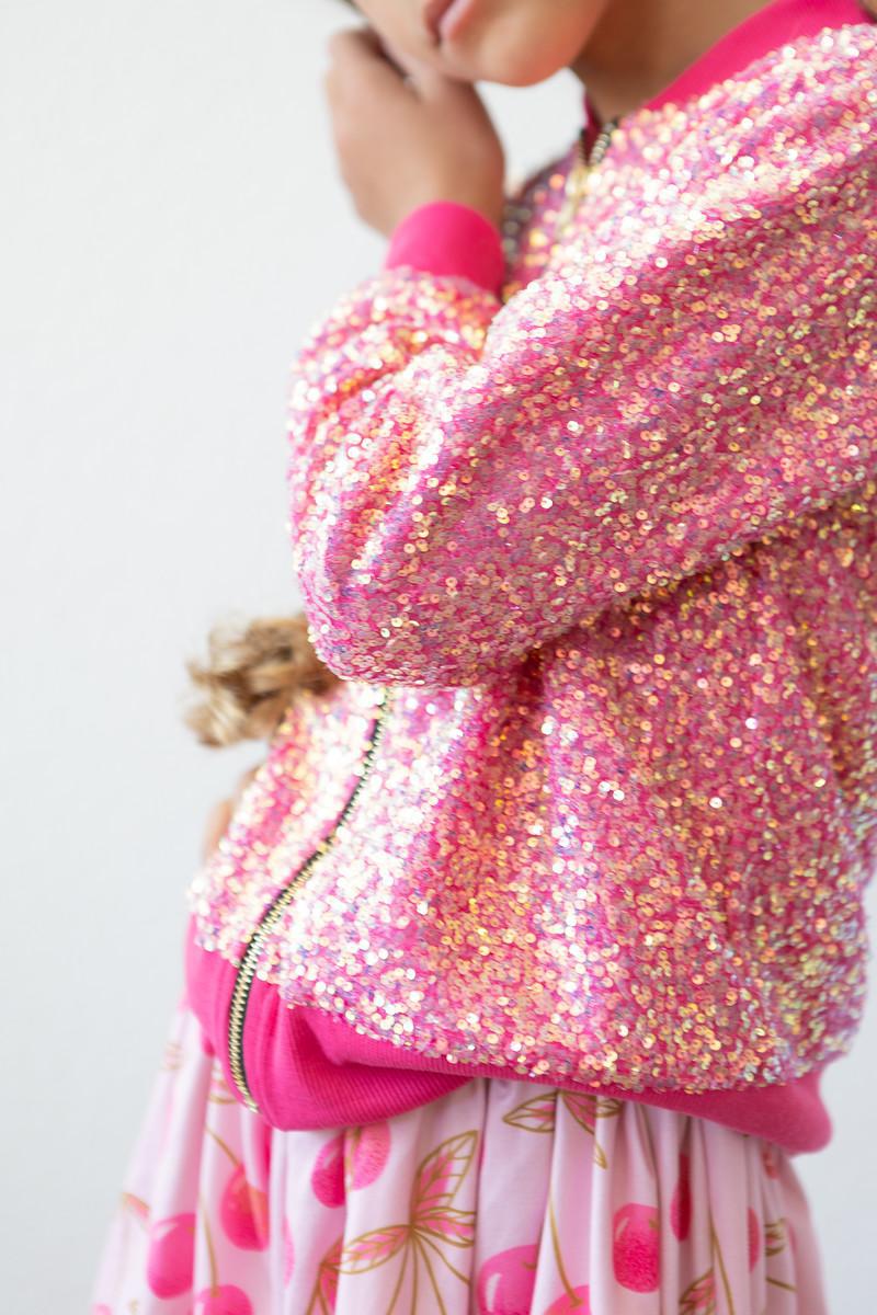 Close-up of the Hot Pink Sequin Jacket by Mila & Rose, featuring eye-catching sequins and a stylish pink trim, ideal for playful fashion moments.