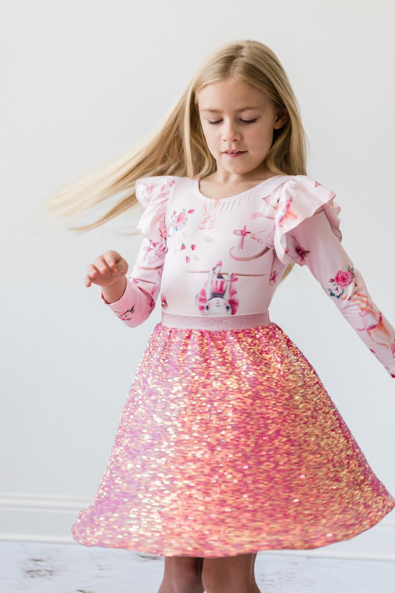 Stylish girl twirling in her Hot Pink Sequin Twirl Skort from Mila & Rose, showcasing the dazzling movement of sequins and the fun of a fashionable twirl.
