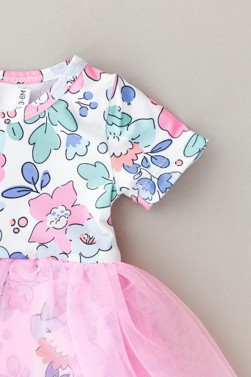 Detailed shot of the sleeve and tulle skirt of the Hydrangea Tutu Bodysuit, highlighting its soft fabric and stylish design.