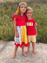 Girls Back To School Pencil Patchwork Twirl Dress with red top, ruffle sleeves and vibrant patchwork skirt.