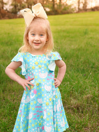 The back view of the Aqua Spring Chicken Floral Farm Print Dress for Girls, illustrating its comfortable fit and playful design.