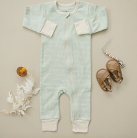 Desert green organic cotton zip romper with "I Love You" script pattern, GOTS certified safe baby clothing, styled with sandals and teether.