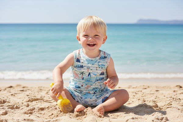 Children's sleeveless romper with dinosaur print on a white background