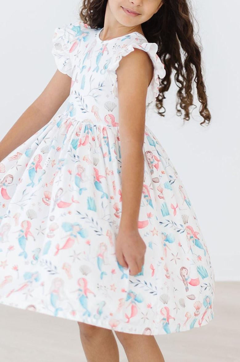 Mermaid Friends Flutter Sleeve Twirl Dress with pastel mermaid and seashell print, flutter sleeves, twirl skirt