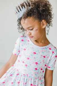 Girl wearing Mermaid Scales Short Sleeve Pocket Twirl Dress; pastel scale print, full twirl skirt, crown headband.