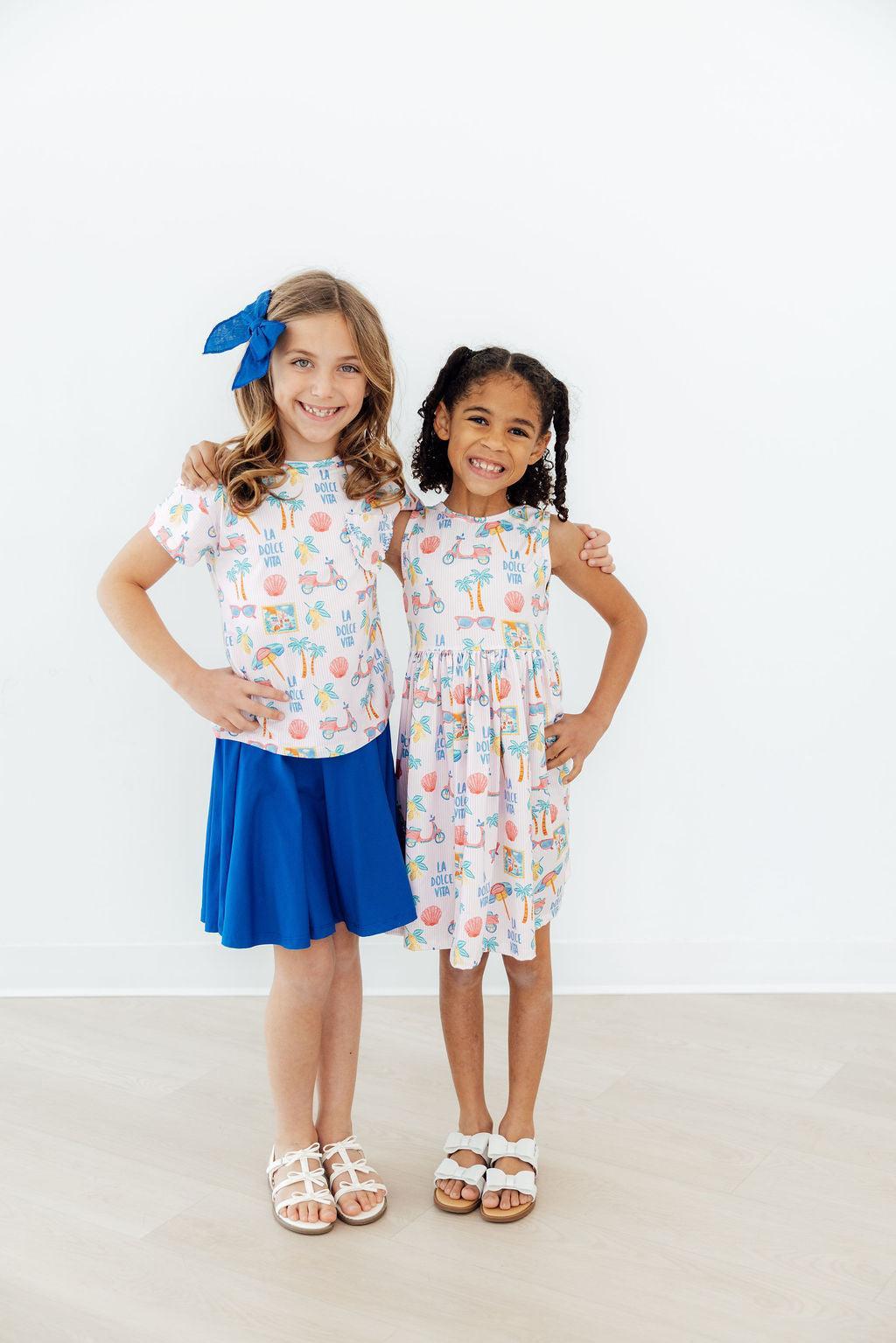 Model wearing the Sweet La Dolce Vita Summer Tank Twirl Dress for Girls, perfect for school and play.