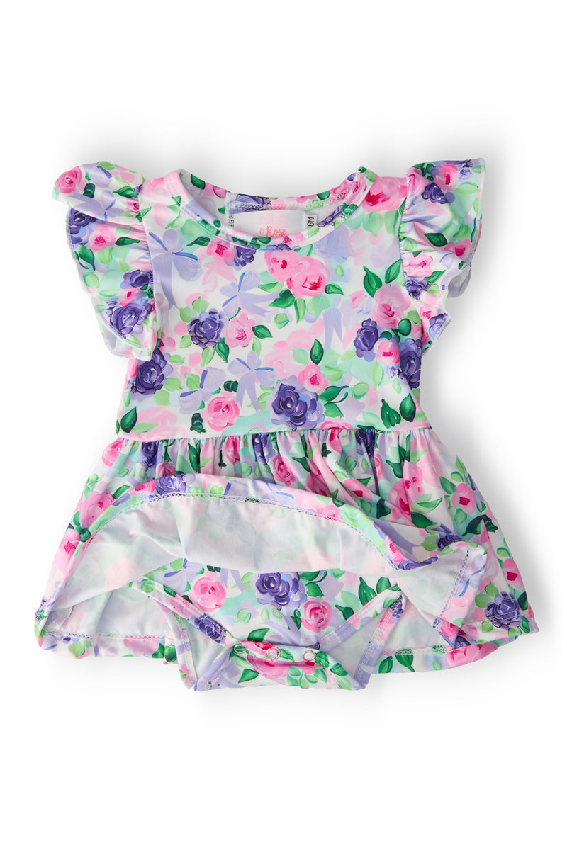 Back view of Lavender Love S/S Flutter Twirl Bodysuit showcasing its delightful floral print and convenient snap closure, ideal for hassle-free diaper changes.