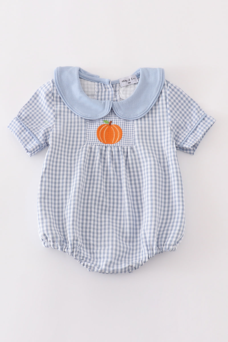 Blue woven check boy bubble romper with solid blue Peter Pan collar and orange pumpkin embroidery on the front pocket.