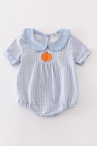 Blue woven check boy bubble romper with solid blue Peter Pan collar and orange pumpkin embroidery on the front pocket.