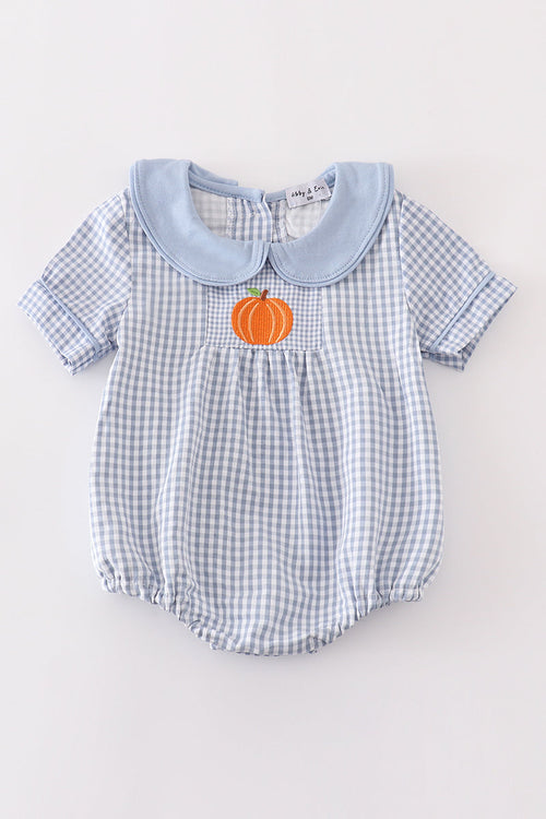 Blue woven check boy bubble romper with solid blue Peter Pan collar and orange pumpkin embroidery on the front pocket.