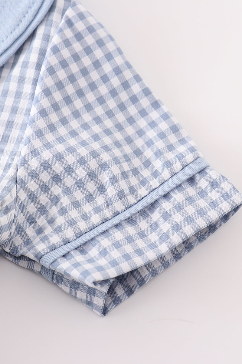 Blue woven gingham fabric detail for a boy bubble romper featuring a ribbed cuff and playful check pattern.