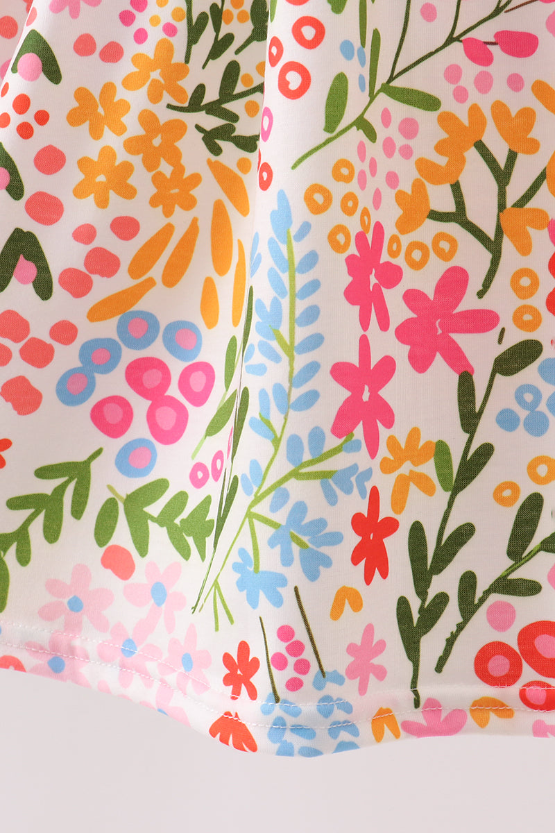 Two fabric swatches with colorful floral patterns on a white background