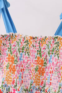 Floral fabric with blue handles on a white background