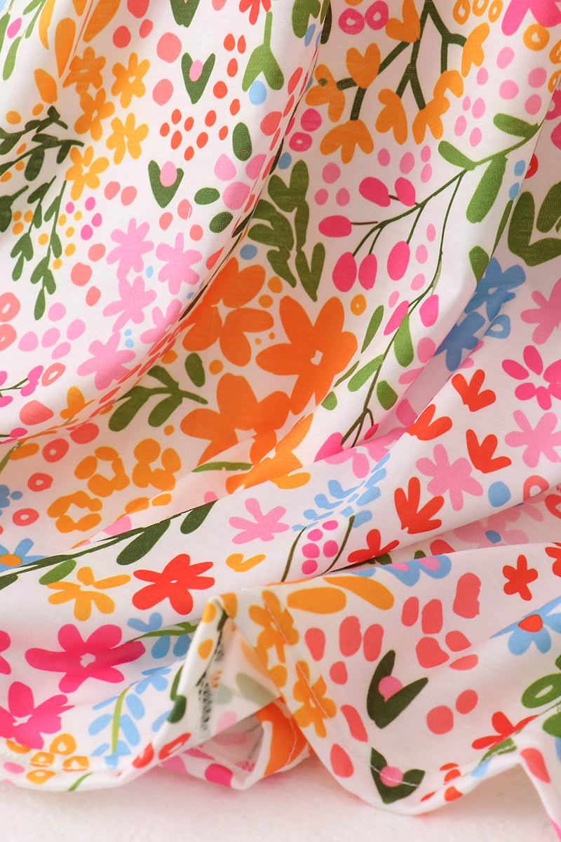 Colorful floral fabric with pink, orange, green, and blue flowers on a white background