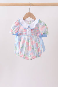 Floral baby romper with a white collar on a wooden hanger against a white background
