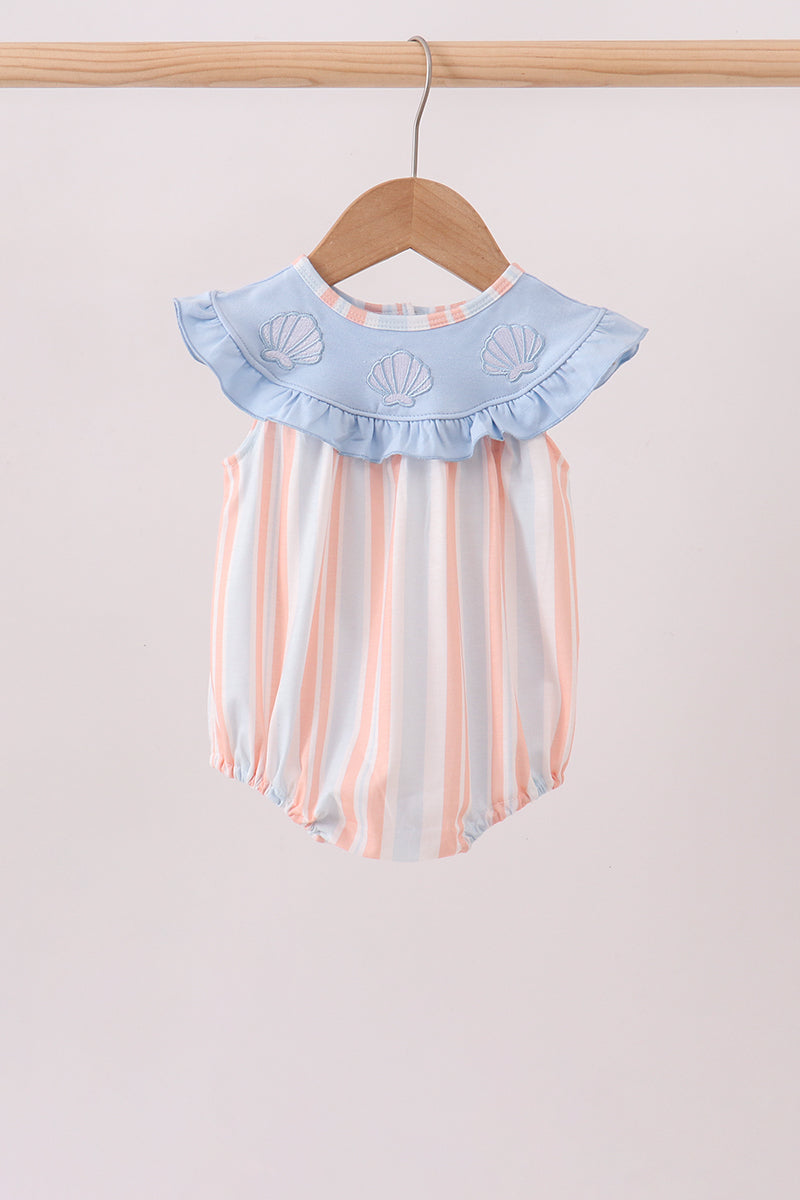 Pink and blue stripe baby bubble romper with ruffled collar and embroidered seashells hanging on wooden hanger