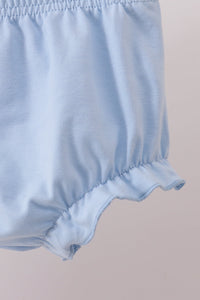 Light blue baby bloomer shorts with elasticized ruffled leg opening and soft breathable fabric for comfortable everyday wear.