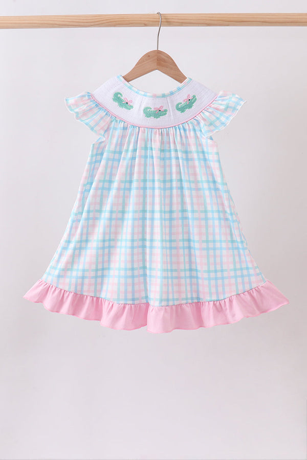 Pink Crocodile Smocked Gingham Dress with pastel gingham, smocked crocodile yoke, flutter sleeves, pink ruffle hem.