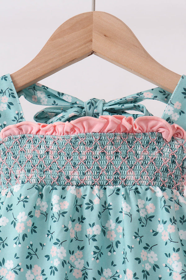 Green floral smocked top with pink ruffle trim and matching turquoise bloomers, a two-piece set.