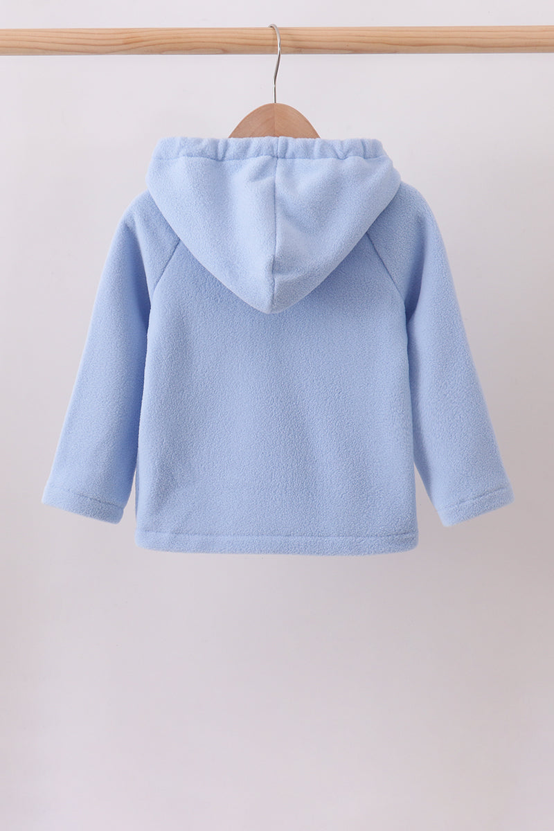 Back view of a light blue toddler fleece hoodie hanging on a wooden hanger, featuring a soft plush texture and structured hood for cozy comfort.