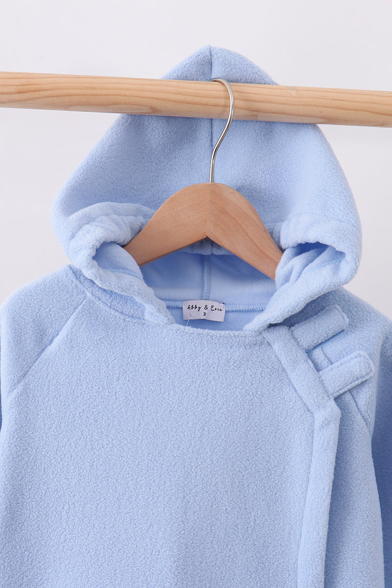 Light blue toddler fleece hooded coat with structured bow detail on shoulder, hanging on wooden hanger.