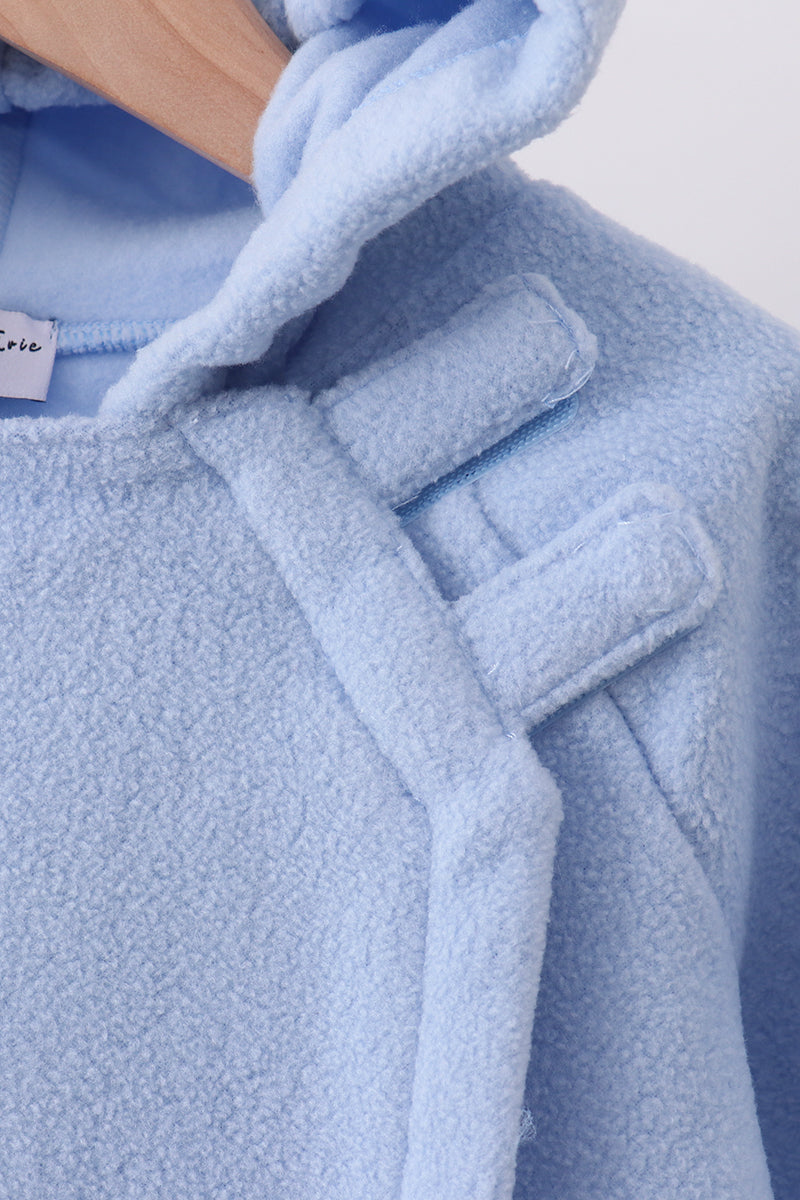 Close-up of a blue fleece bow coat on a hanger, showcasing plush 100% polyester texture and structured shoulder details for toddlers.