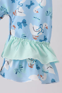 Blue baby romper featuring white goose print, blue bows, and a mint green ruffled hem for comfortable, playful style.