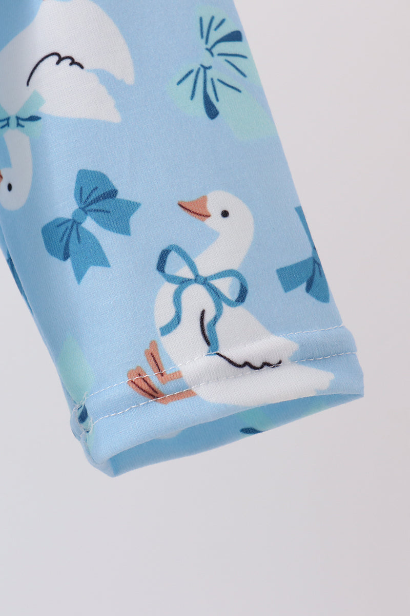 Light blue baby romper fabric featuring cute white goose prints with blue bows and delicate stitching detail on the cuff.