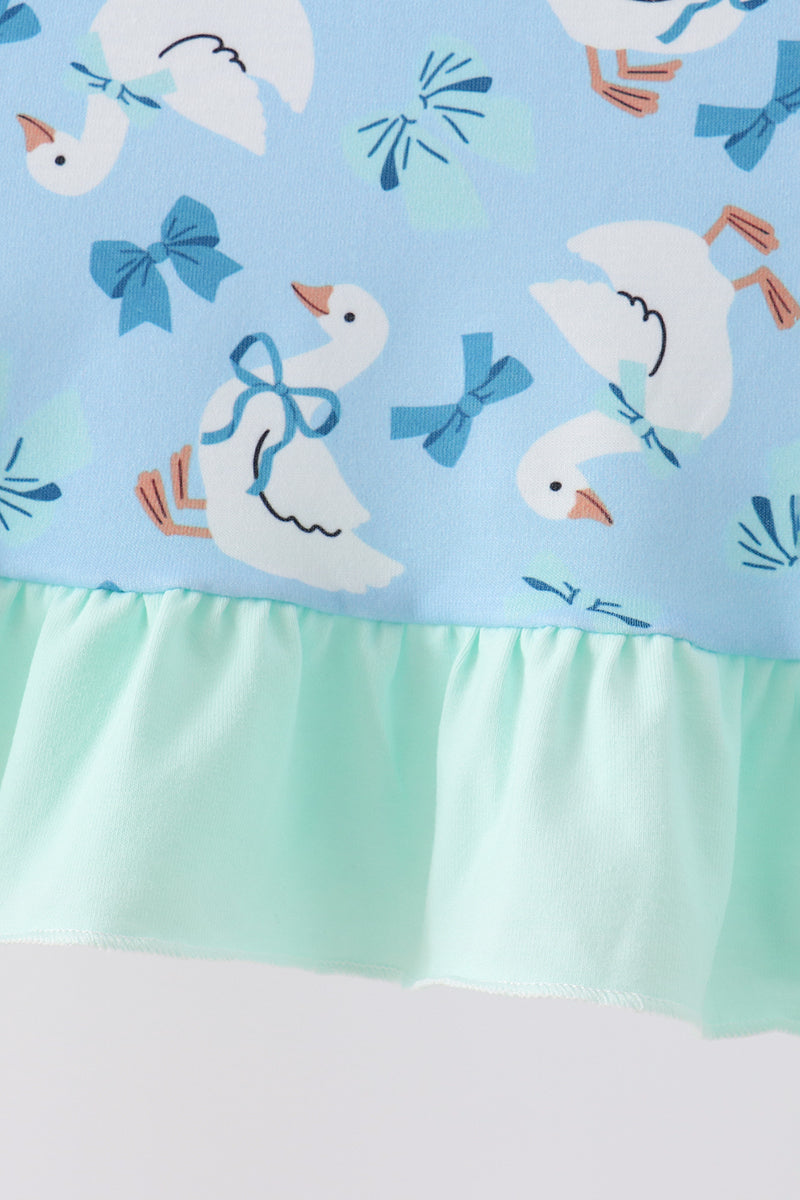 Blue goose print dress fabric with bow details and mint green ruffle hem. Whimsical and elegant儿童 apparel design.
