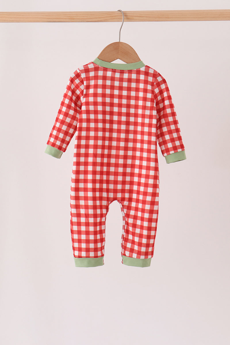 Back view of red and white gingham baby romper with light green trim on neck, cuffs, and ankles hanging on a wooden hanger.