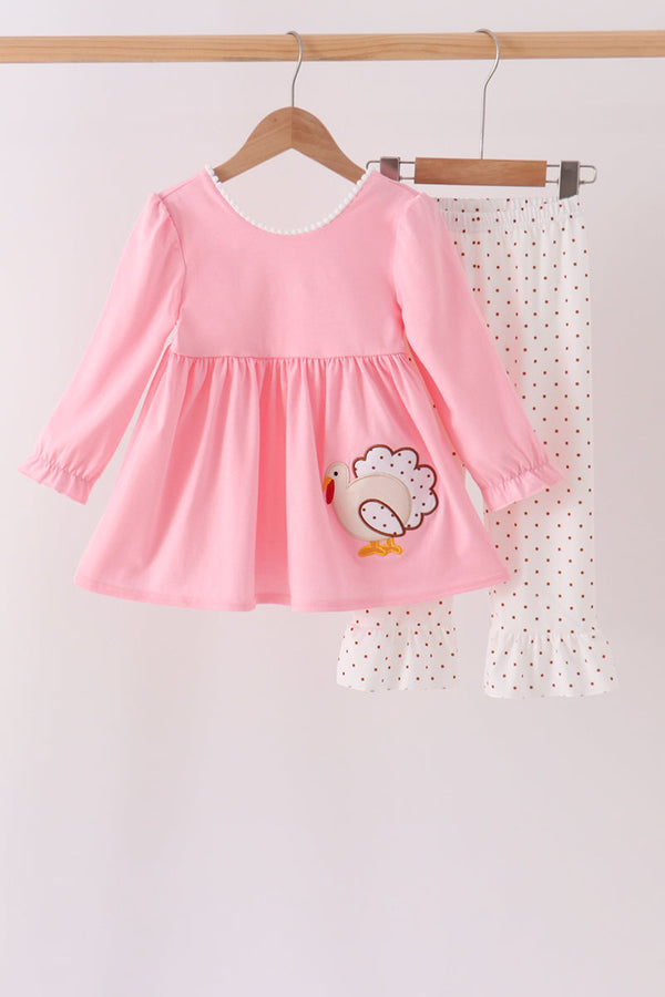 Pink toddler dress with embroidered turkey applique paired with white polka dot ruffle pants for festive fall wear.