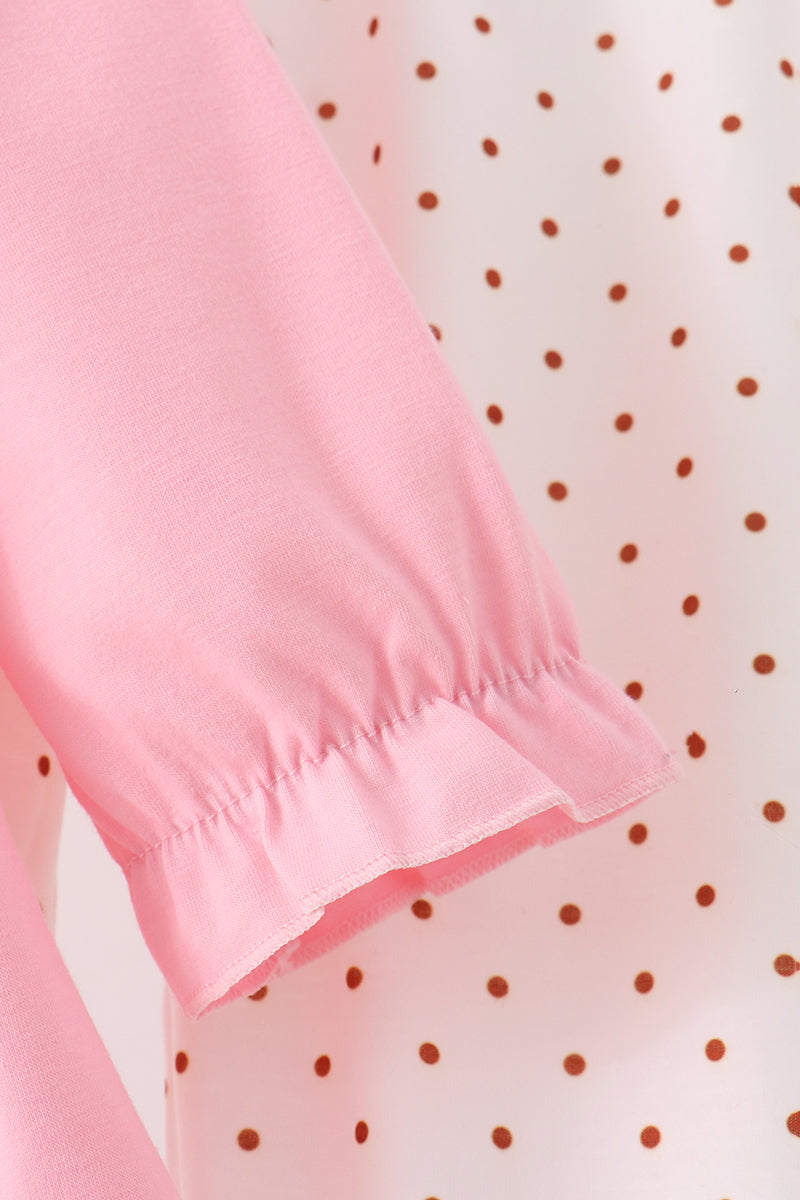 Pink ruffle cuff sleeve and brown polka dot fabric detail from a toddler turkey applique pants set.