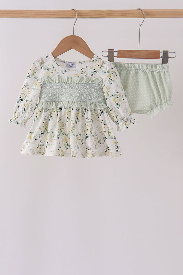 Sage floral smocked ruffle bloomer set featuring a long-sleeve top with delicate green florals, intricate bodice smocking, and playful ruffle detailing on the matching bloomers.