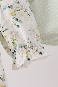 Sage floral smocked ruffle bloomer set featuring delicate floral print, vintage-inspired ruffled hem, and soft green polka dot detail.