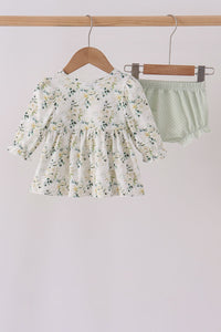 Sage floral smocked ruffle bloomer set with delicate florals, vintage-inspired top, and polka dot ruffled shorts on wooden hanger.