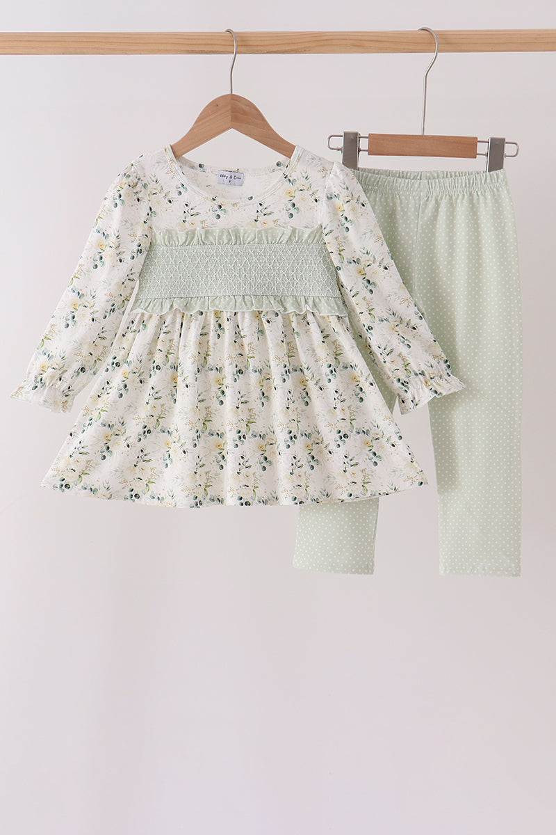 Floral print smocked dress with green ruffle detail paired with mint polka dot pants in a charming two-piece outfit.