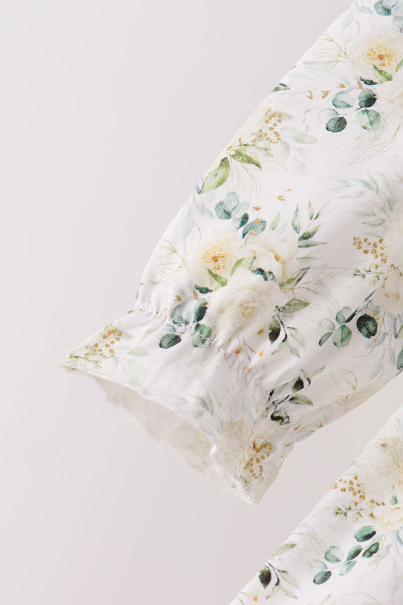 Sage floral print pants leg with delicate ruffle cuff detail. Soft botanical pattern on lightweight fabric for a comfortable fit.