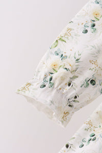 Sage floral print pants leg with delicate ruffle cuff detail. Soft botanical pattern on lightweight fabric for a comfortable fit.