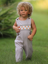 Toddler boy in Fall Halloween & Thanksgiving Pumpkin Smock Embroidered romper with pumpkin embroidery.
