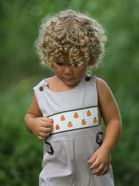 Fall Halloween & Thanksgiving Pumpkin Smock Embroidered Boys Romper with pumpkin embroidery on gray check fabric.