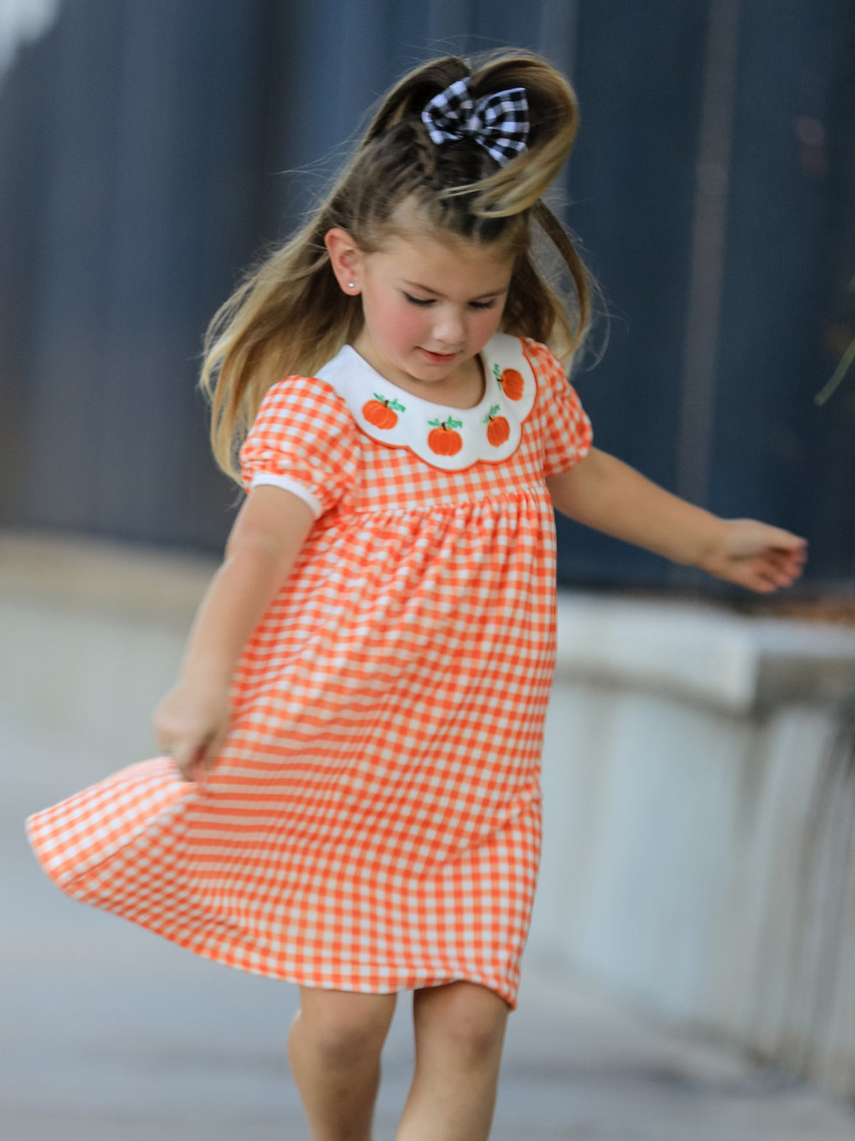 Orange gingham puff sleeve dress for girls with embroidered pumpkins on a white scalloped collar, perfect for fall.