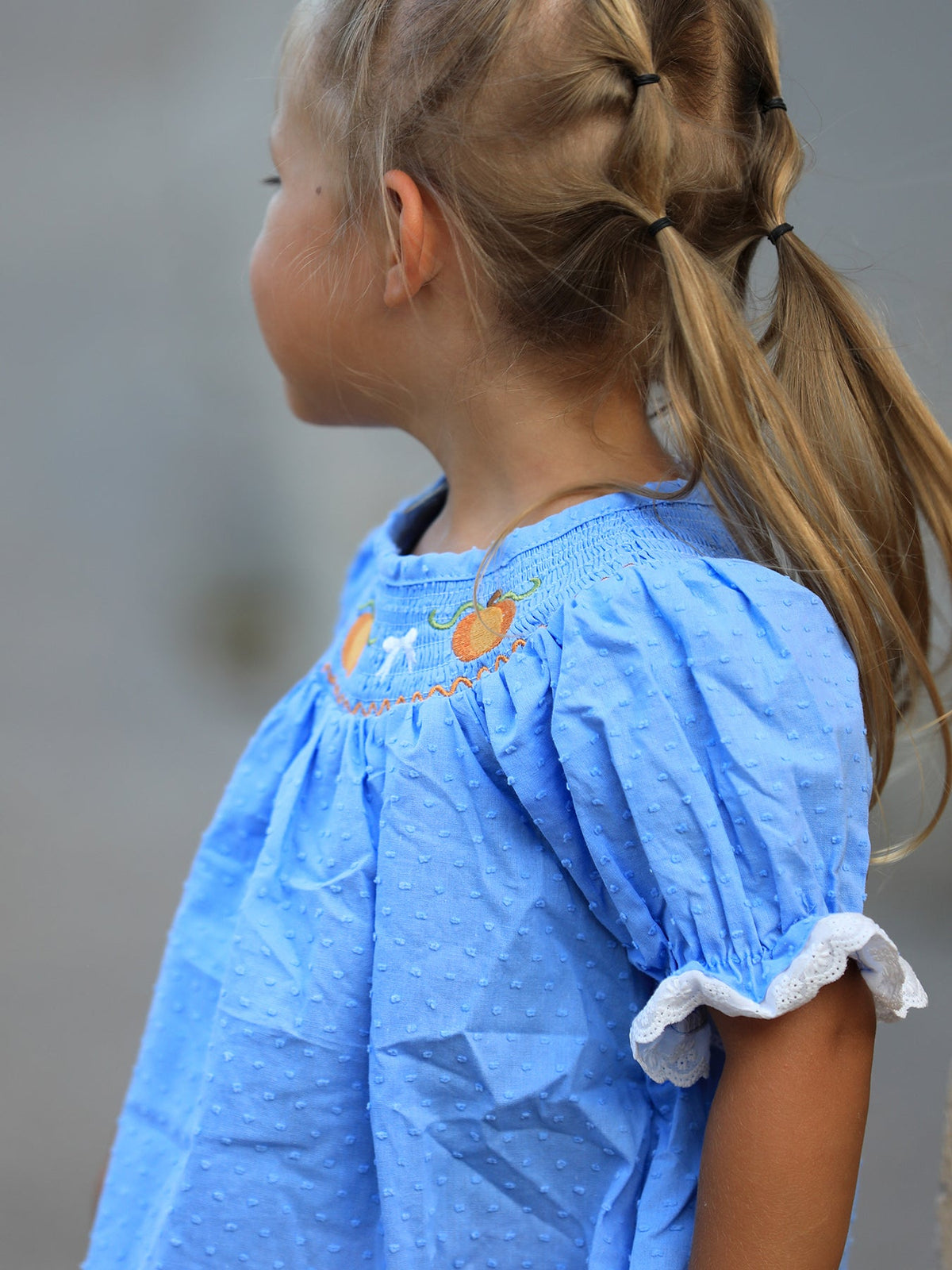 Blue fall baby girl dress with pumpkin embroidery, lace smock details, perfect for Thanksgiving and Halloween.