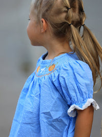 Blue fall baby girl dress with pumpkin embroidery, lace smock details, perfect for Thanksgiving and Halloween.