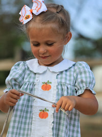 Girl's fall pumpkin-applique plaid green dress with white collar.