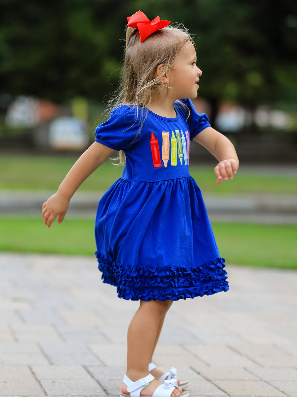 Little girl twirling in the Girls Back To School Crayon Twirl Dress, a fun and functional girls back to school dress.