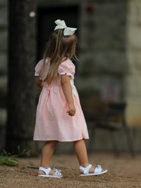 Pink girls dress with puff sleeves, lace petals collar, and Western horse embroidery on smocked bodice.