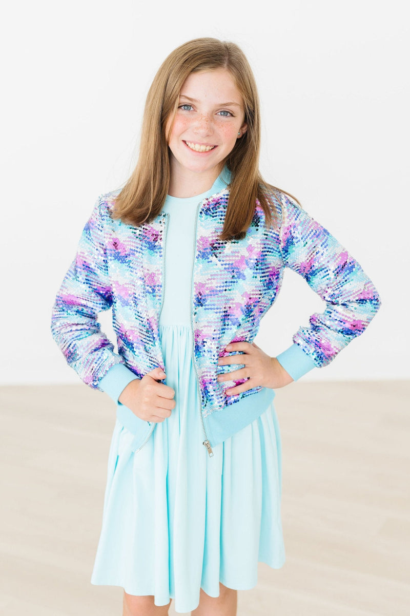 Smiling girl wearing the Mermaid Sequin Jacket, radiating joy and charm, ideal for dancing and play.