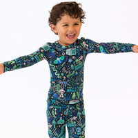 Child in blue The Second-Skin 2-Piece Long Sleeve Pajama with You Made Magic pattern.