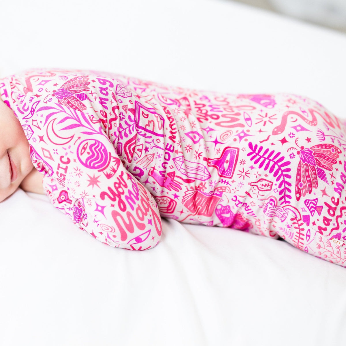 Baby sleeping in a pink Mystic Mama second-skin romper with Raising Mama viscose from bamboo.